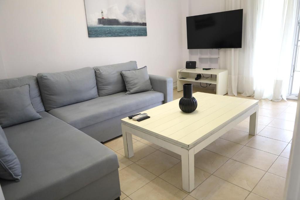 a living room with a couch and a coffee table at seasideepanomi in Epanomi