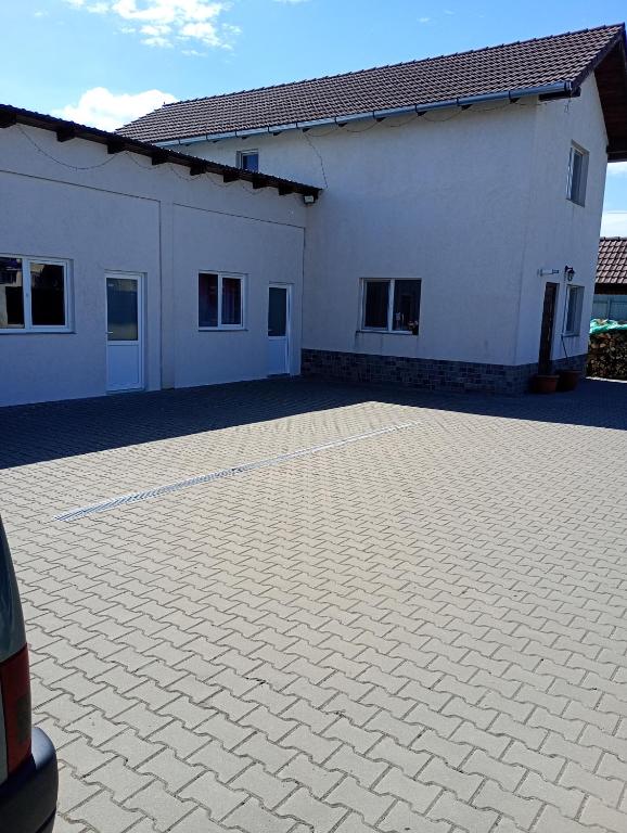 a large white building with a large driveway at Casa Tamara in Turda