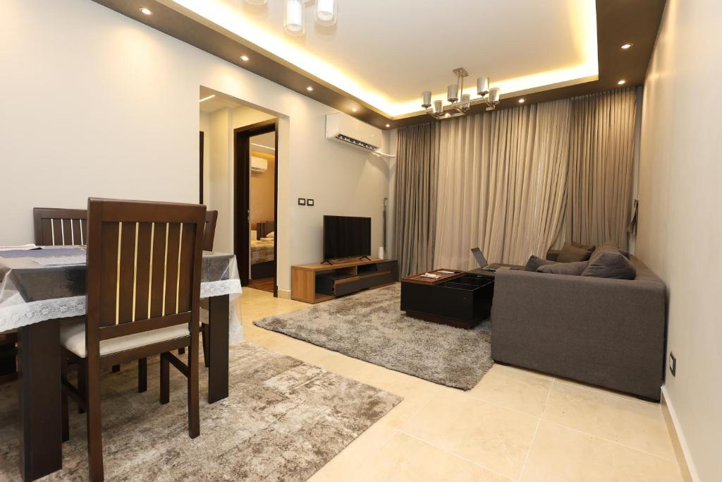 a living room with a couch and a table at Madinaty Gateway Prime Apartment B12 in Madinaty