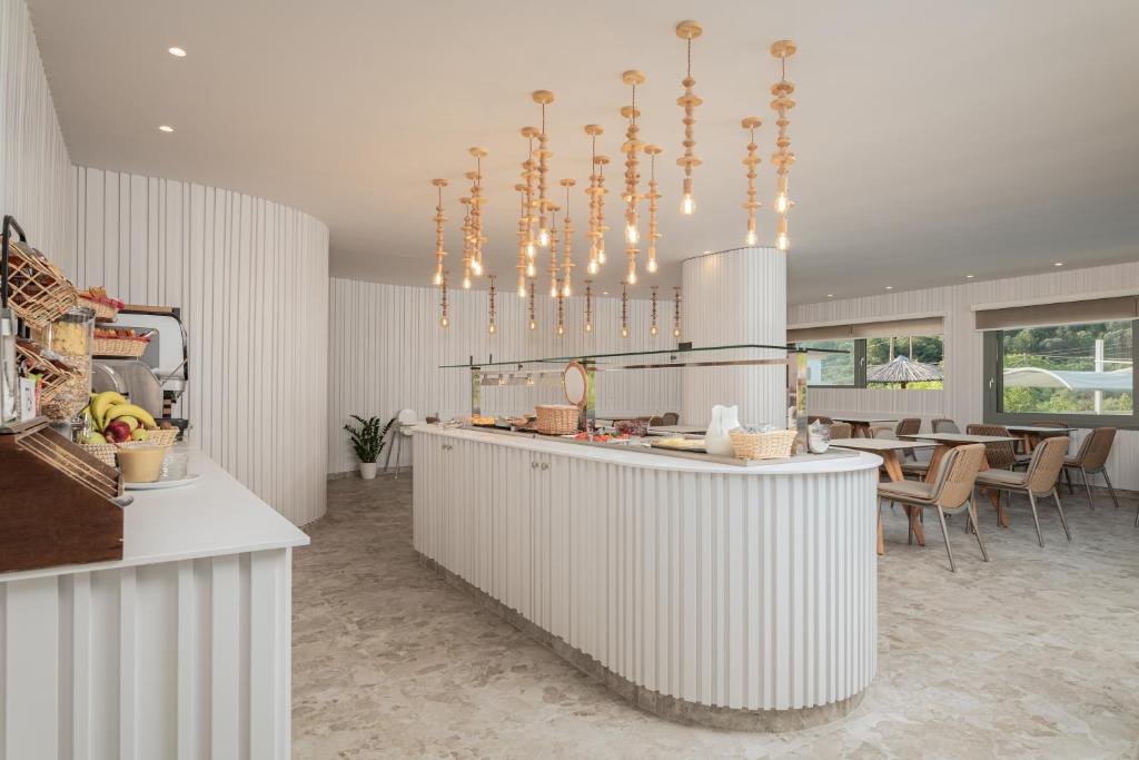 a kitchen with a counter and a dining room at Kokkari Beach Hotel in Kokkari