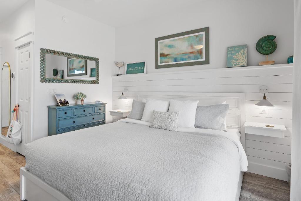 a white bedroom with a white bed and a blue dresser at 30A Rosemary-Alys Beach-5min Walk to Beach- Sleeps 3 in Rosemary Beach