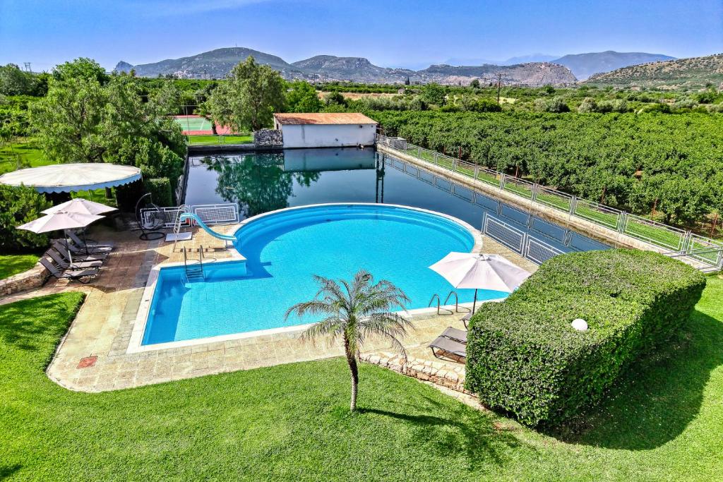 a swimming pool in the middle of a yard at Orange Grove Villa in Nafplio