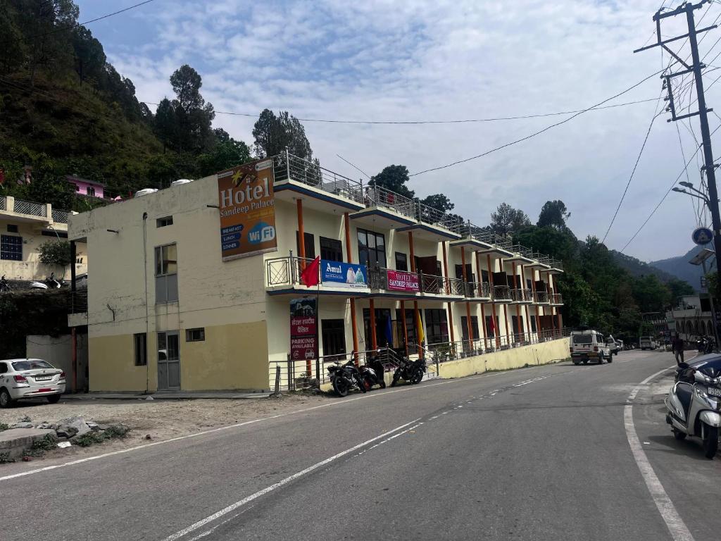 a large building on the side of a street at Hotel Sandeep palace in Jāmb