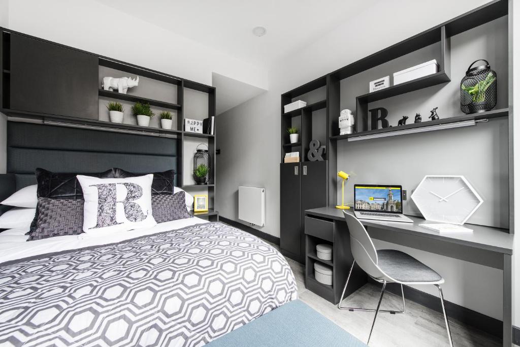 a bedroom with a bed and a desk with a computer at Yugo Explore New Mill in Dublin