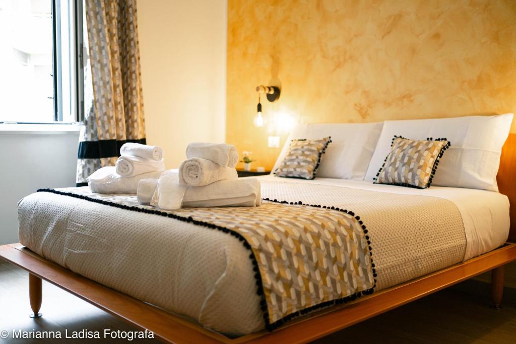 a bedroom with a bed with towels on it at Dimora Capruzzi 37 in Bari