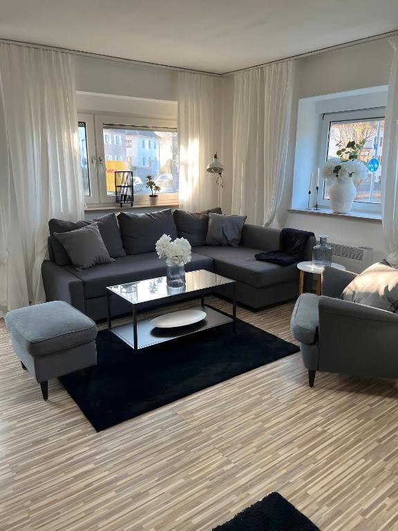 a living room with a couch and a coffee table at Apartments Neckarsulm in Neckarsulm