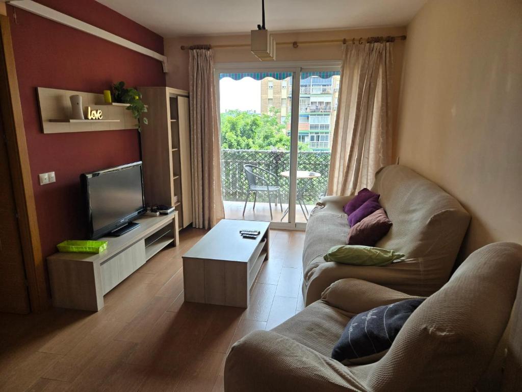 Televízia a/alebo spoločenská miestnosť v ubytovaní Cozy apartment with balcony in Málaga 81 m²