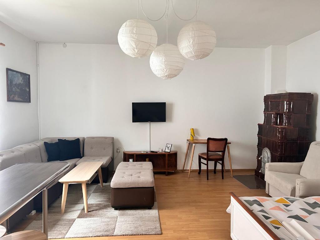 a living room with a couch and a table at Elisaveta's Retreat. Come to feel the tranquility! in Râşnov