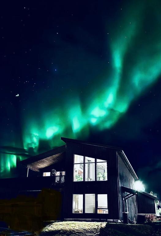 a building with the aurora in the sky at EideKollen in Tromsø