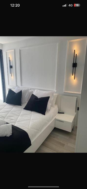 a bedroom with a white bed with crosses on the wall at Studio luxueux et contemporain in Casablanca