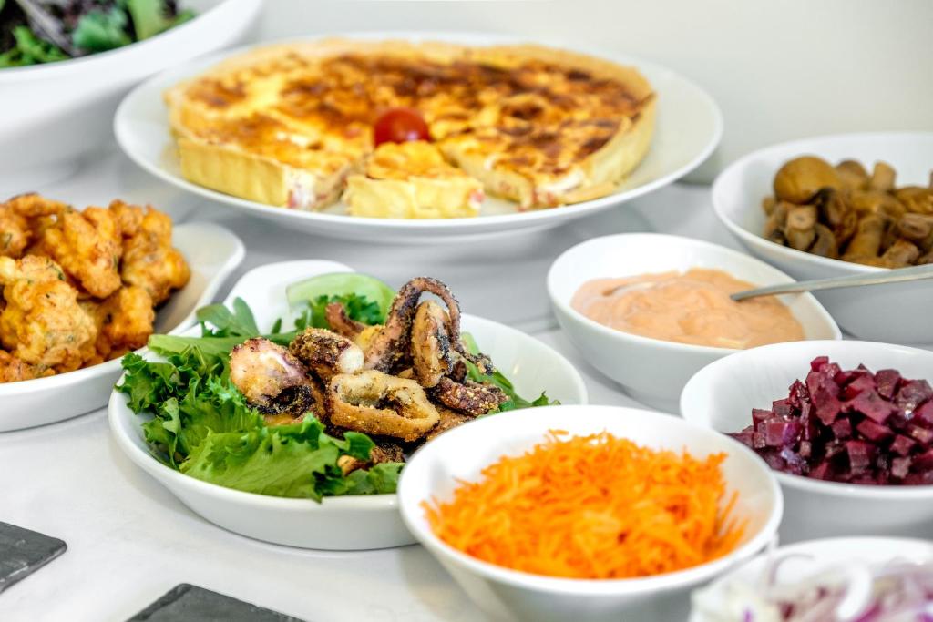 a table with plates of food in bowls at Sintra Boutique Hotel in Sintra
