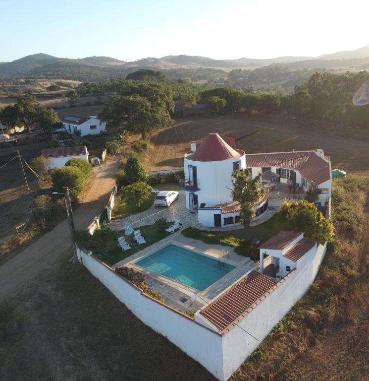 an aerial view of a house with a swimming pool at Windmill Hill in Cercal