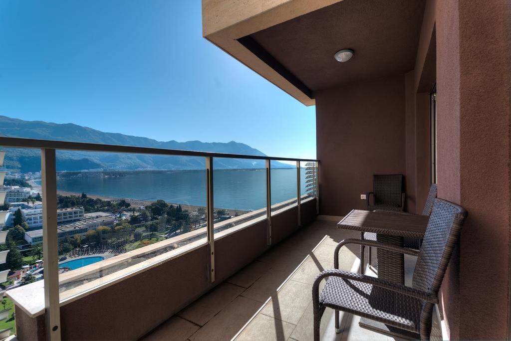 a balcony with a table and chairs and a view at Harmonia Apart Hotel in Boreti