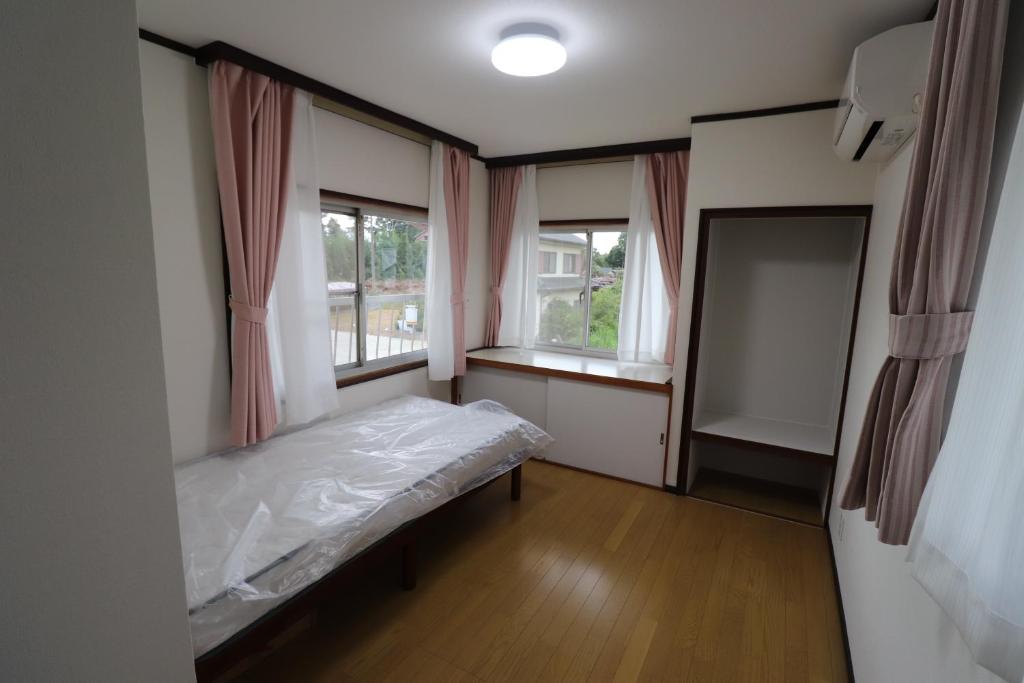 Postel nebo postele na pokoji v ubytování Nagoamisou 大網白里市