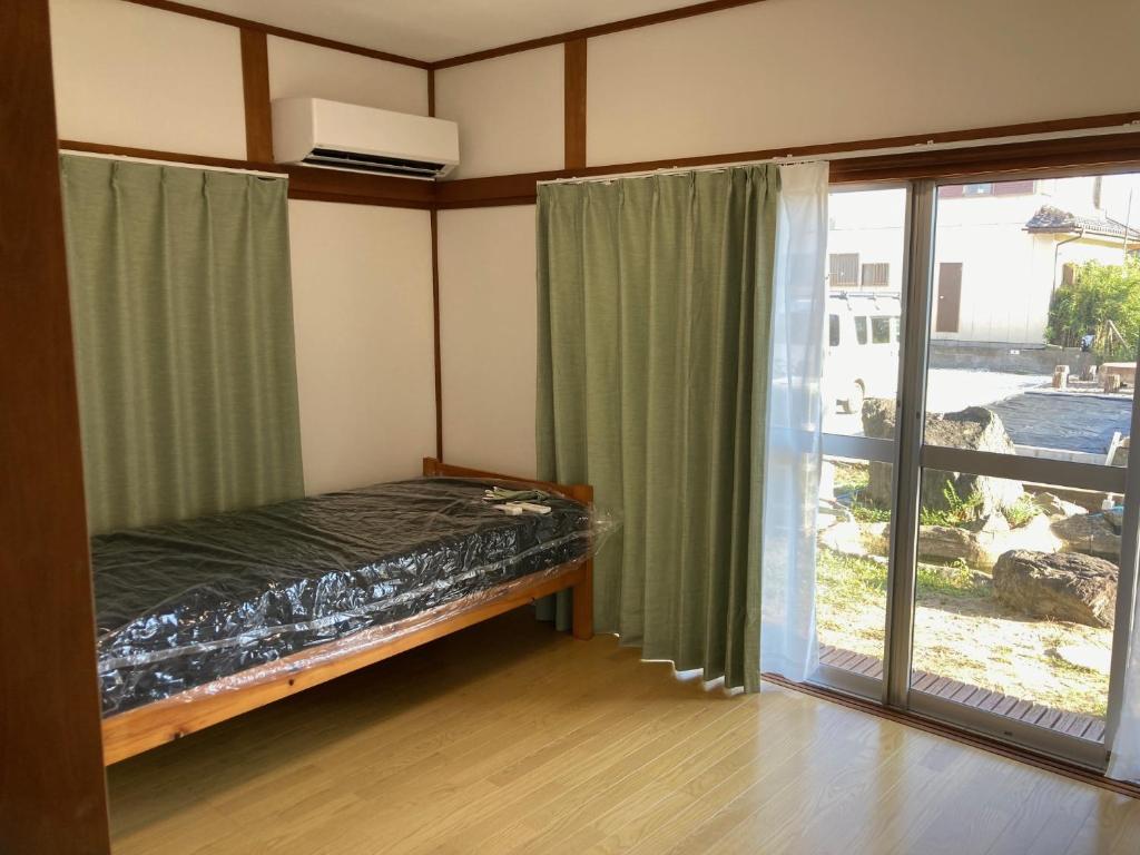Postel nebo postele na pokoji v ubytování Nagoamisou 大網白里市