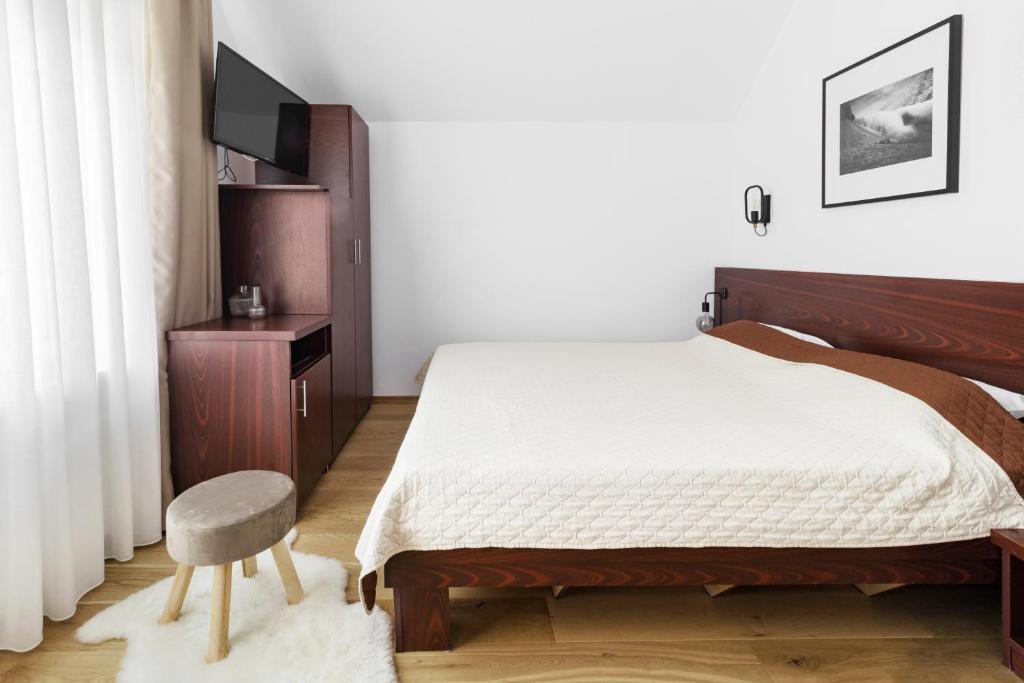 Postel nebo postele na pokoji v ubytování Hotel Piatra Soimului