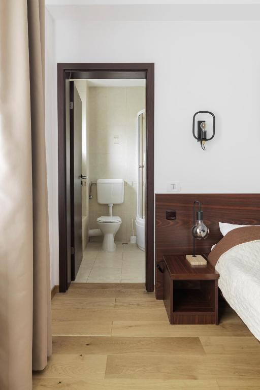 Postel nebo postele na pokoji v ubytování Hotel Piatra Soimului