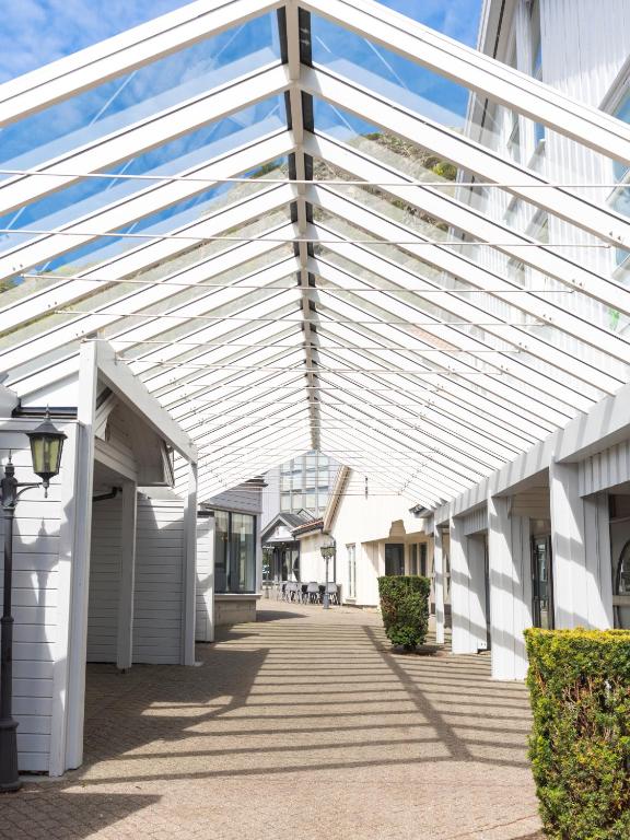 a white pergola over a walkway in a building at Kongsgata Apartments in Figgjo