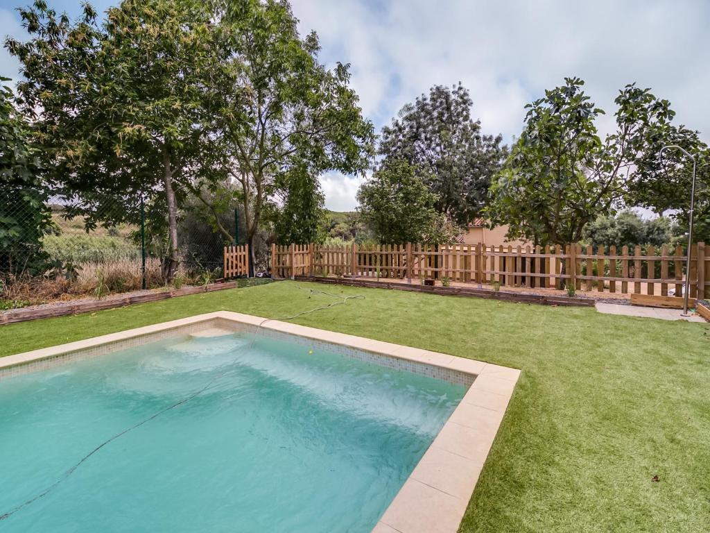 a swimming pool in a yard with a fence at Villa in Palafolls with Private Pool & BBQ in Palafolls