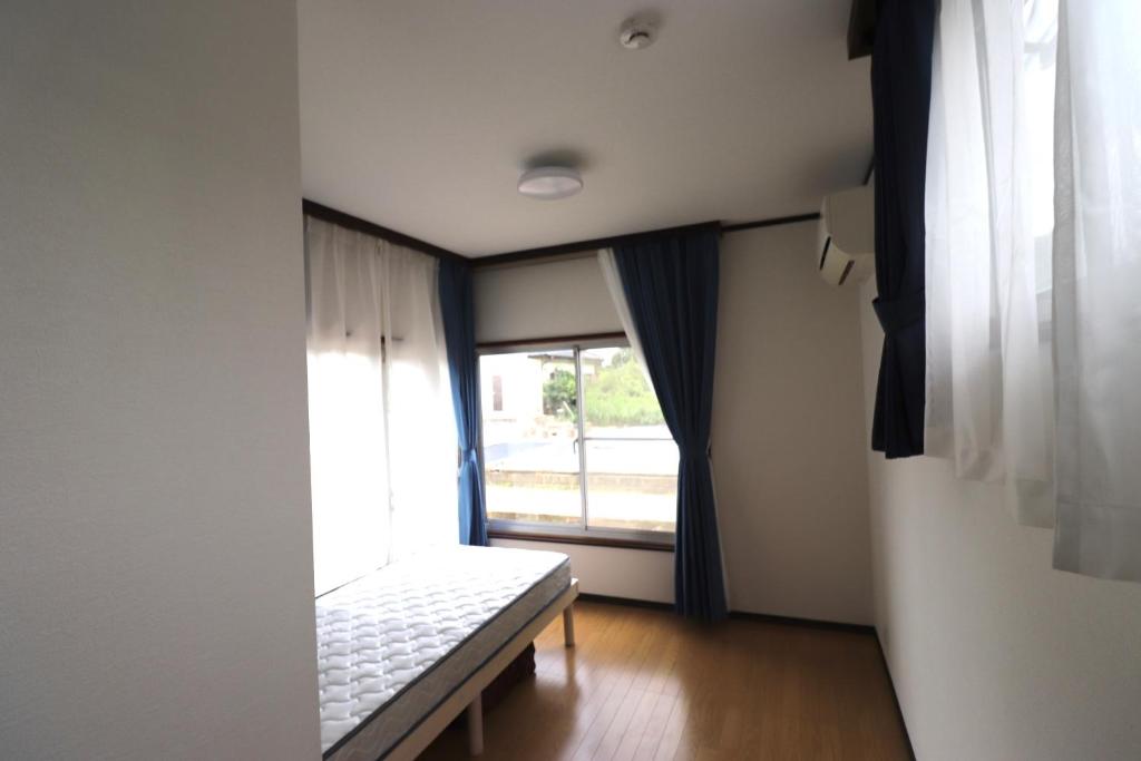 Postel nebo postele na pokoji v ubytování Nagoamisou 大網白里市