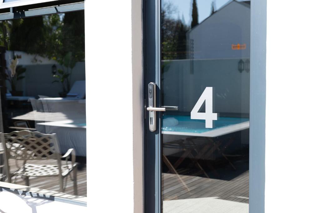 a glass door with the number four on it at Blix Inn Guesthouse in Stellenbosch