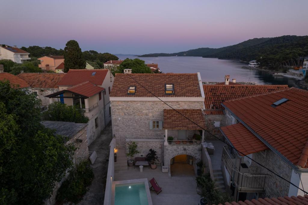 an aerial view of a town with a river and buildings at Stone house Casa Lumina in Božava
