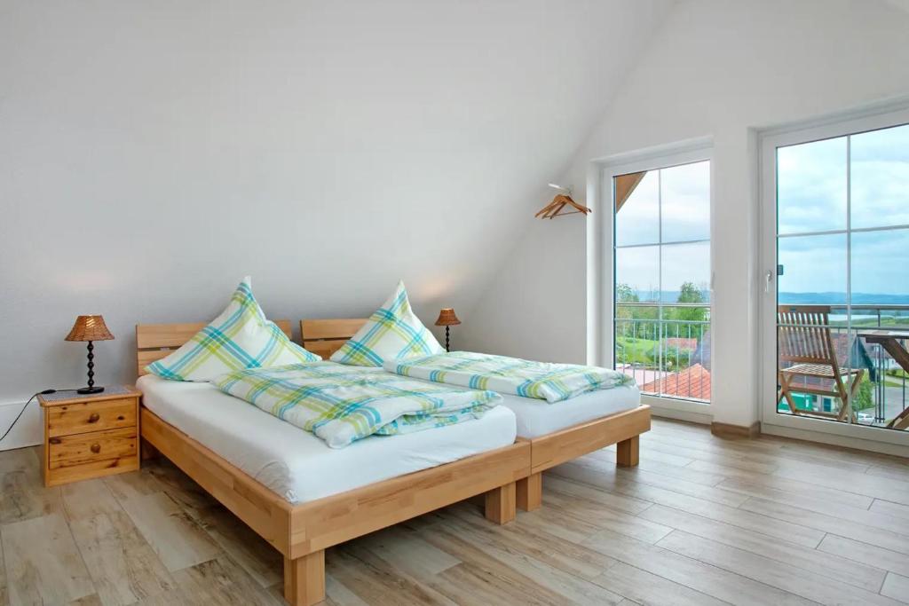 a bedroom with a bed and a large window at Bergsuite in Friedrichshafen