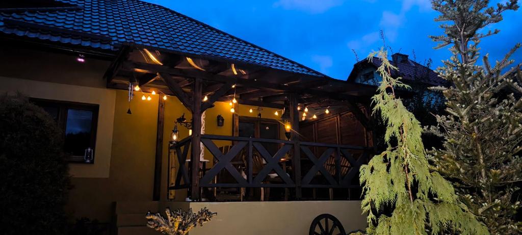a house with a christmas tree in front of it at Na Divokom Vŕšku in Jamník