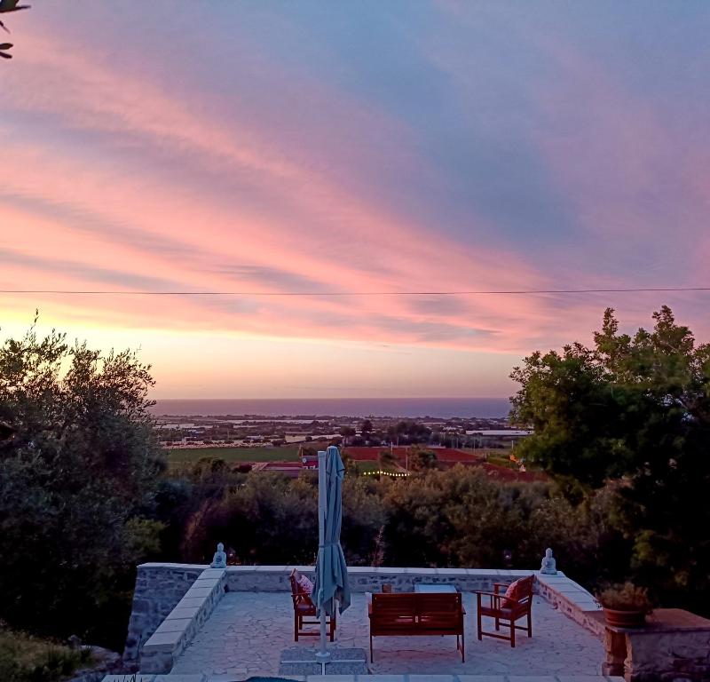 a patio with two chairs and an umbrella and a table at le finestre sul mare in Conversano
