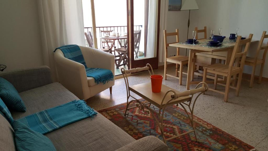 sala de estar con sofá, mesa y sillas en Apartamento Hector en Sitges, en Sitges