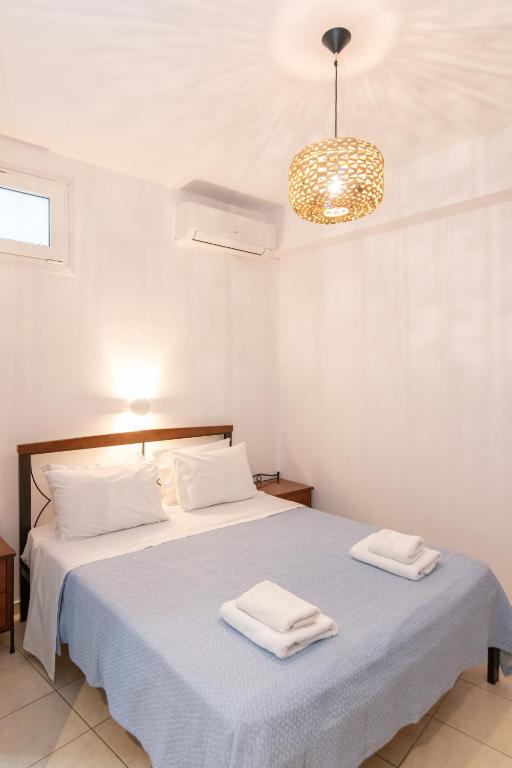 Postel nebo postele na pokoji v ubytování Agapi Hotel Tinos