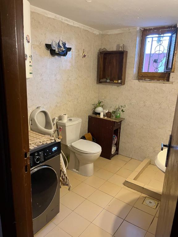 a small bathroom with a toilet and a sink at bayt alrahaal in Amman