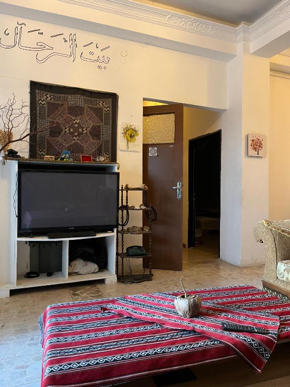 a living room with a flat screen tv on a wall at bayt alrahaal in Amman