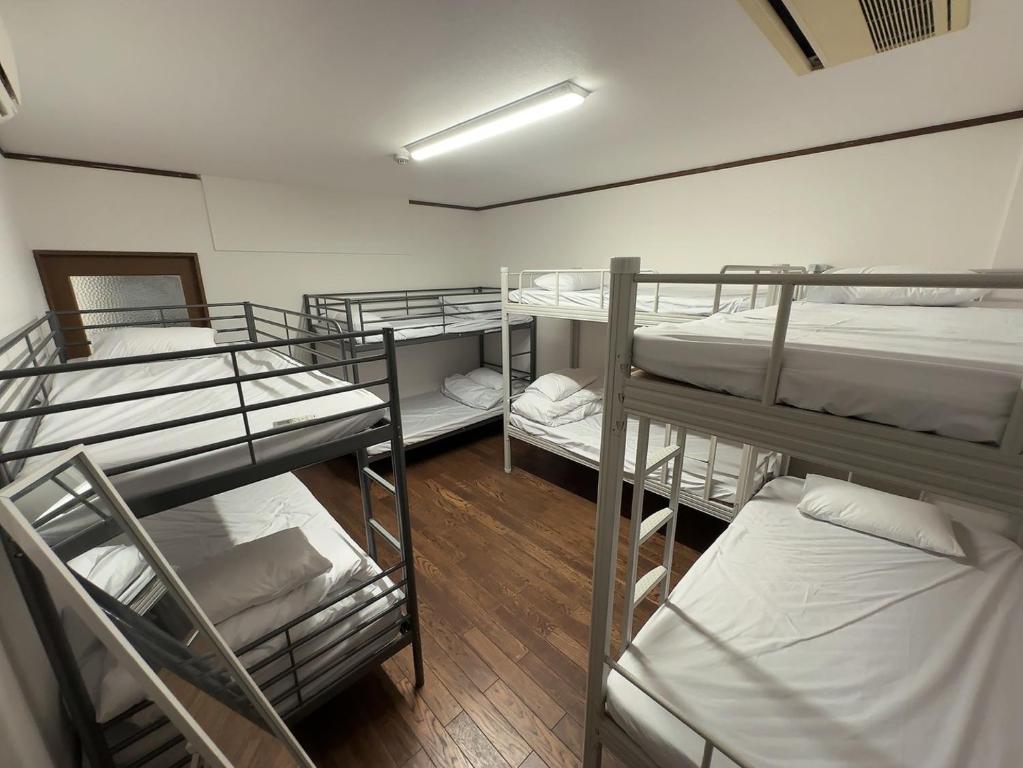 Postel nebo postele na pokoji v ubytování NAMBA Dotonbori HoYaHouse2