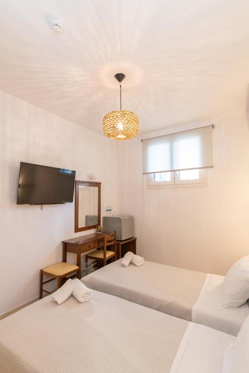 Postel nebo postele na pokoji v ubytování Agapi Hotel Tinos