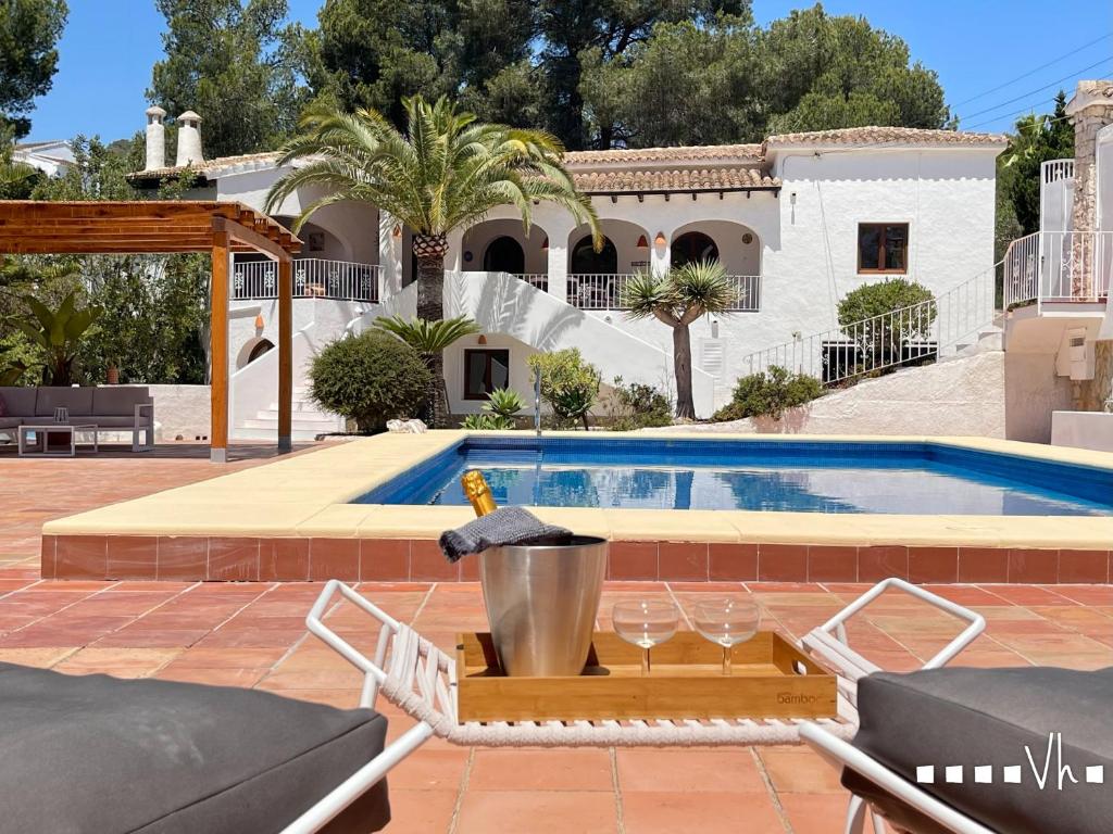 a swimming pool in front of a house at VH CostaBlanca - MIRASOL in Fanadix