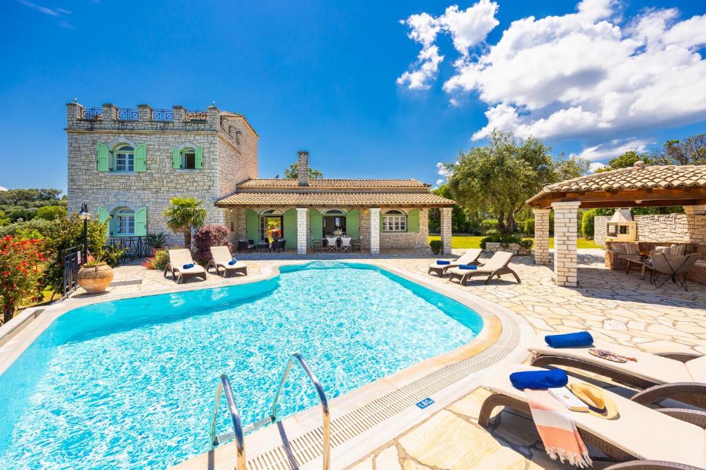 an estate with a swimming pool and a house at Villa Emily in Ágios Stéfanos
