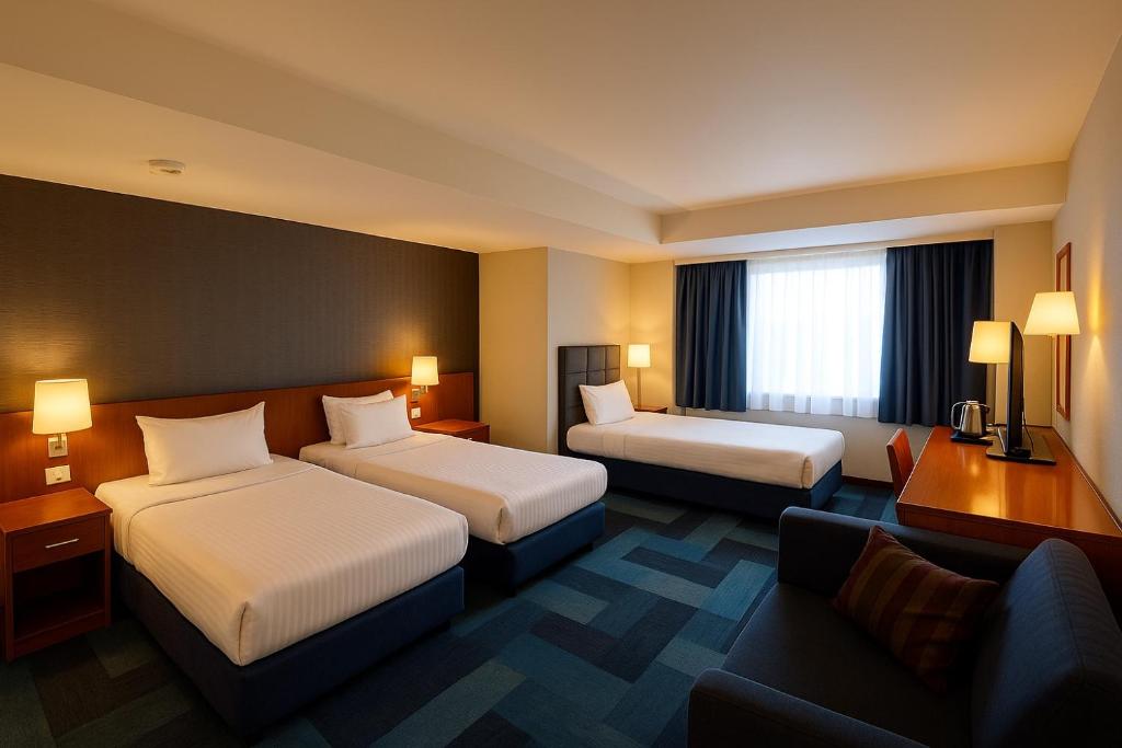 A bed or beds in a room at Taxim Express Bosphorus Hotel