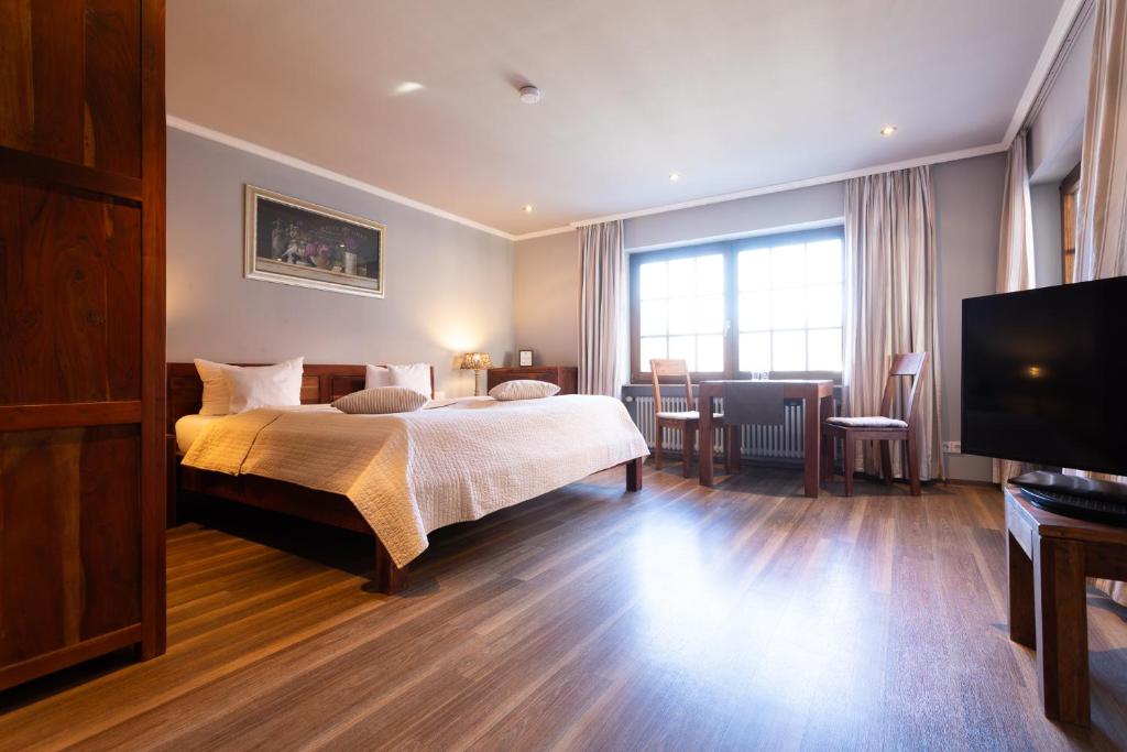 a hotel room with a bed and a television at Appartements by Romantik Hotel zur Sonne in Badenweiler