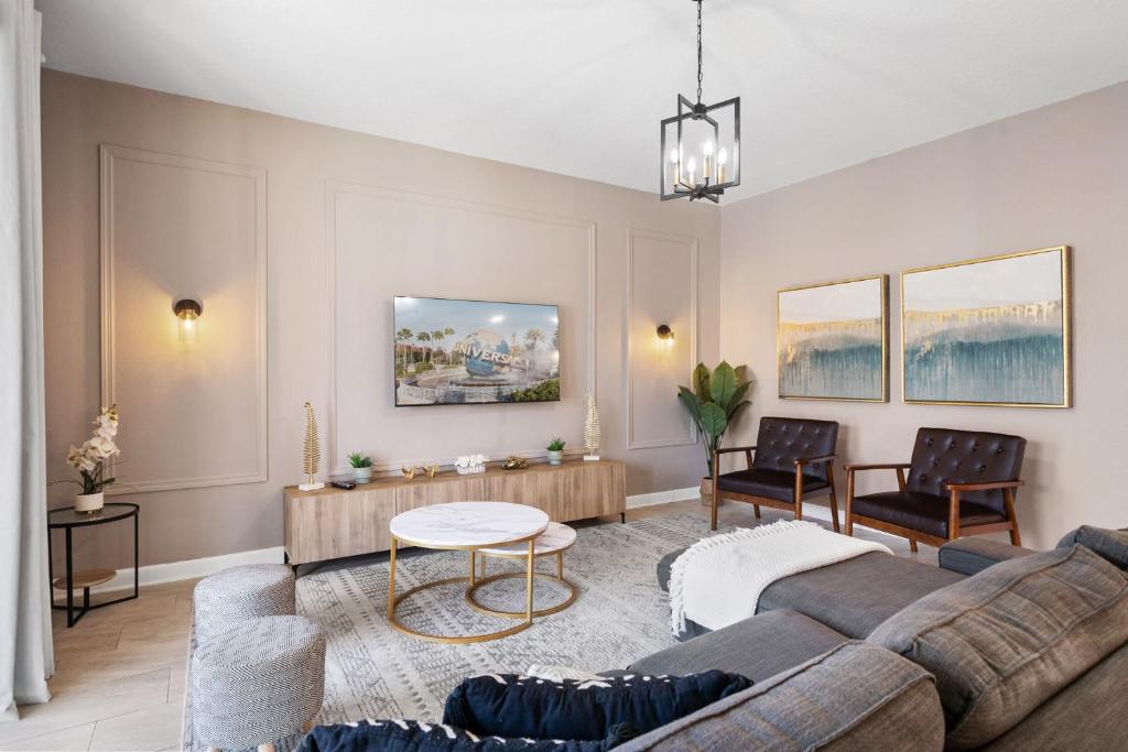 a living room with a couch and a table at Gorgeous 6-bedroom house with private pool in Kissimmee
