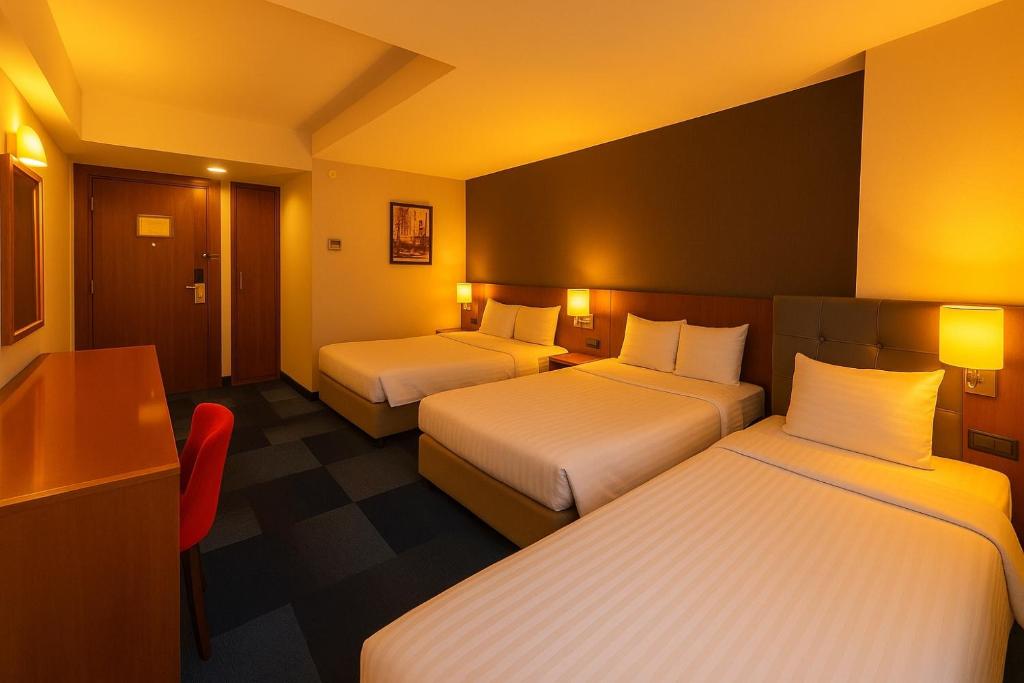 A bed or beds in a room at Taxim Express Bosphorus Hotel