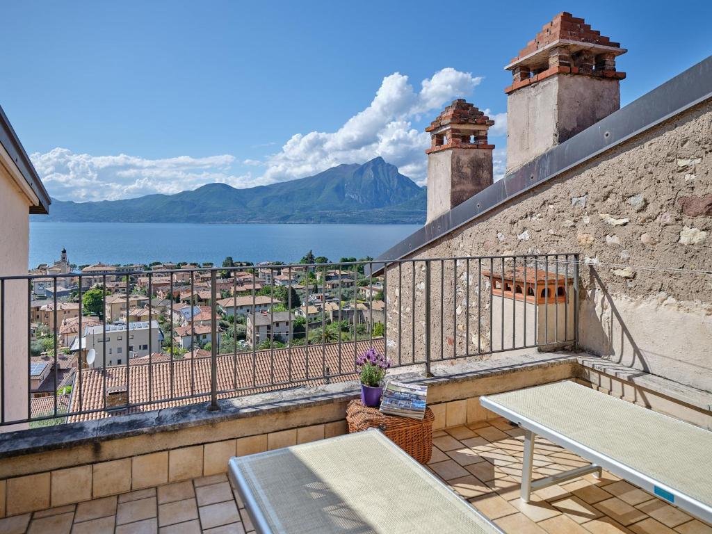 a balcony with a table and a view of the water at La Casa di Mia - country house in Torri del Benaco