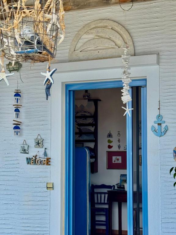 a door to a house with a sign that reads welcome at Aloni House in Triandáros