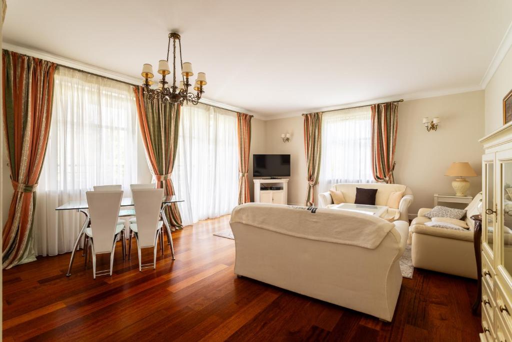 a living room with a couch and a table at Victus Apartamenty, Apartament Ocean in Sopot