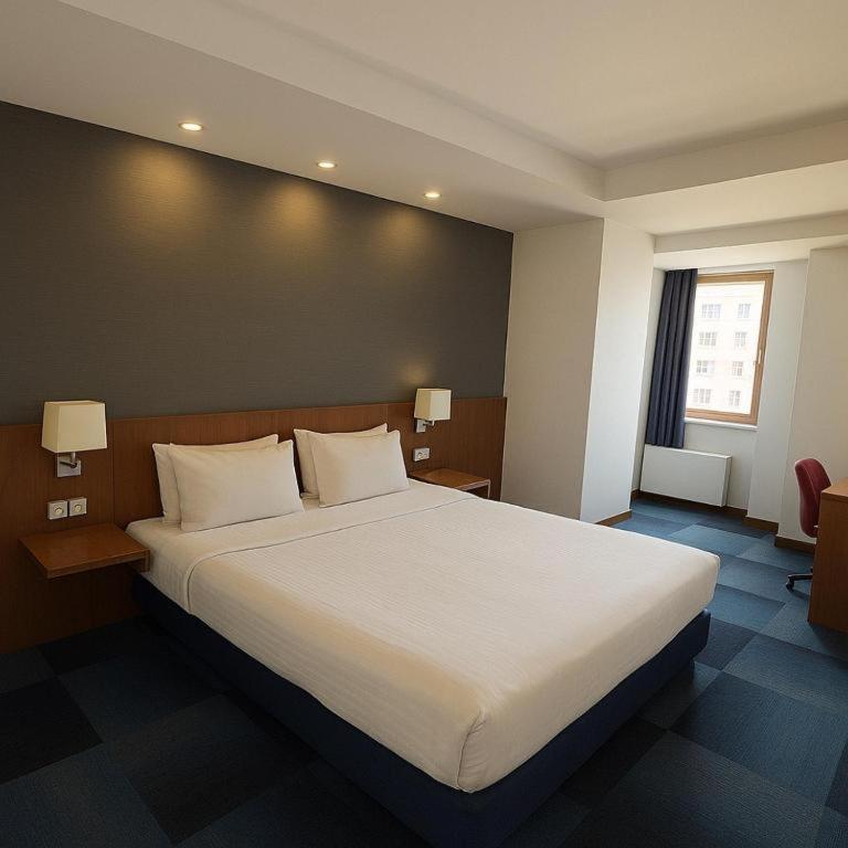 A bed or beds in a room at Taxim Express Bosphorus Hotel