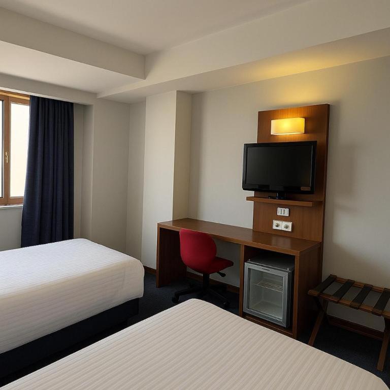 A bed or beds in a room at Taxim Express Bosphorus Hotel