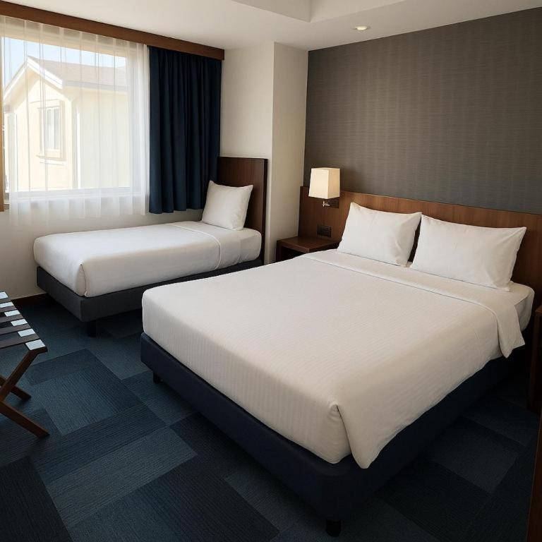 A bed or beds in a room at Taxim Express Bosphorus Hotel