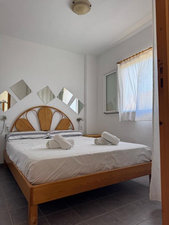 a bedroom with a large bed with two towels on it at Edificio Es Pujols 10 ALTA TURISTICA in Es Pujols