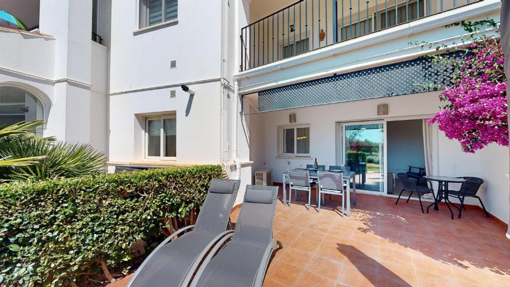 a patio with chairs and tables in a building at Casa Indico J-Murcia Holiday Rentals Property in Sucina