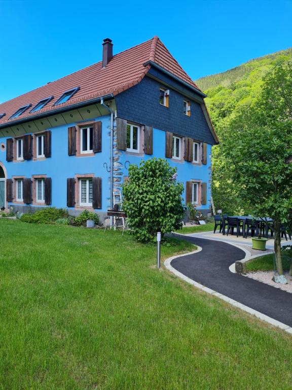 ein großes blaues Gebäude mit einem Weg davor in der Unterkunft la maison bleue in Sainte-Marie-aux-Mines